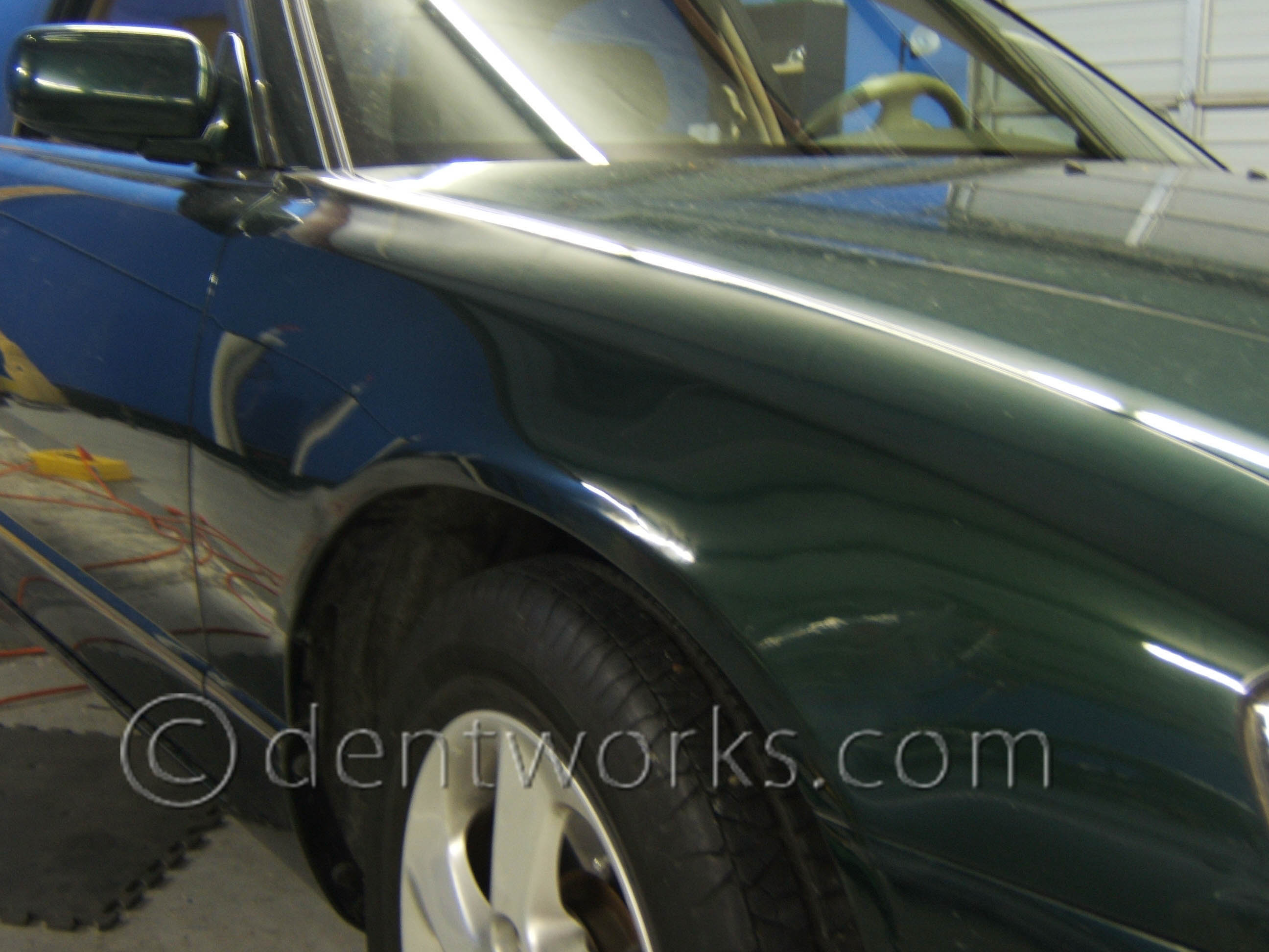 Green Mazda with the minor dent repaired